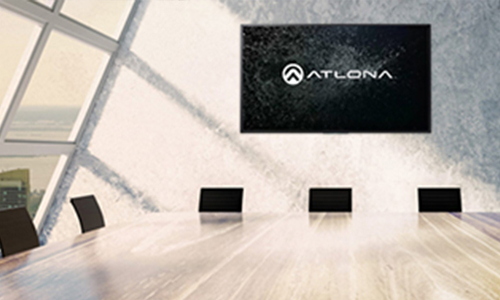 Meeting room with the Atlona logo on a flatscreen TV mounted to the wall
